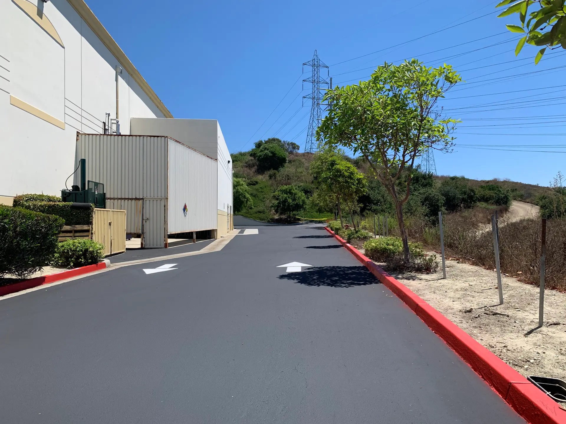 Fresh directional arrow striping on a commercial drive lane by Native Union Engineering